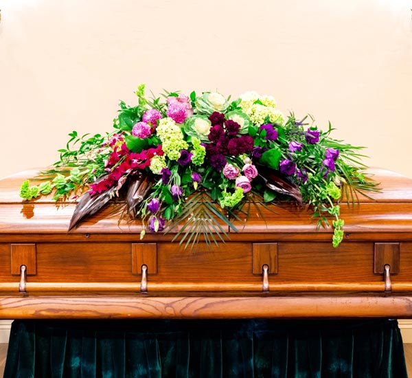 TRANQUILITY CASKET SPRAY Funeral Flowers in Athens, OH - HYACINTH BEAN  FLORIST